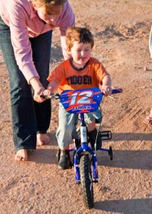 Of course, sometimes the things they love are things we don't need to actually go anywhere to do.  Edmund got his first bike for his third birthday, and just loves riding around like his older siblings.
